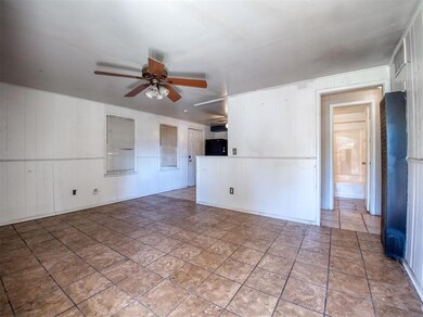 Spare room featuring ceiling fan and tile patterne