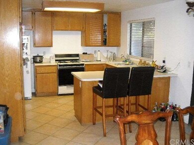 KITCHEN WITH BREAKFAST BAR AND TILE FLOORING