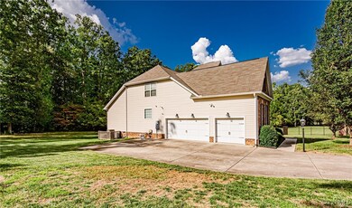 View of home's exterior with a lawn and a garage