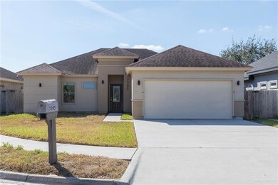 View of front of property with a shingled roof, driveway, stucco siding, and an attached garage