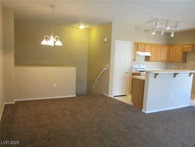 Kitchen featuring white gas range oven, track ligh
