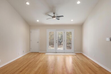 Spare room featuring baseboards, light wood-style