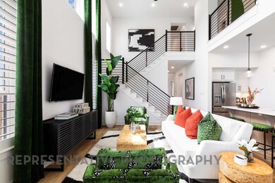 Living area with recessed lighting, a high ceilin