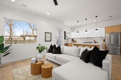Living room with light wood-style floors, baseboa