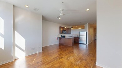 Kitchen featuring stainless steel appliances, hanging light fixtures, dark wood finished floors, a peninsula, and recessed lighting