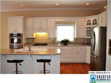 Updated eat-in kitchen with white cabinetry, quart