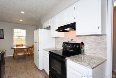 Granite kitchen counters with new back splash.