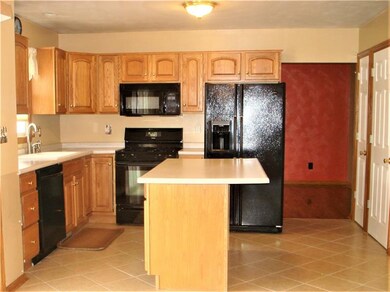 The eat-in-kitchen features an island and doors le