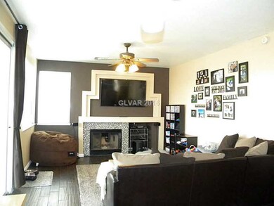 Den. Includes slider to covered patio, fireplace and ceiling fan.