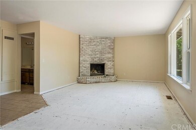 Large wood-burning fireplace with white-washed bri
