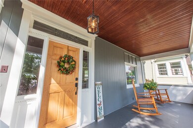 Stunning covered front porch with original hardwoo