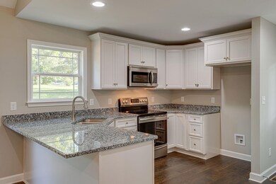This is the same plan being built. Photo is taken from another build. Buy now and help select your finishes. Stainless appliances include microwave, dishwasher and range.