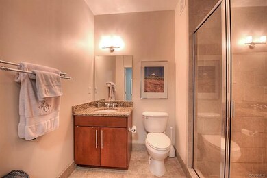 Guest bath has tile floors, and walk-in shower wit
