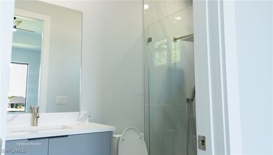 Full bathroom with toilet, a stall shower, vanity,