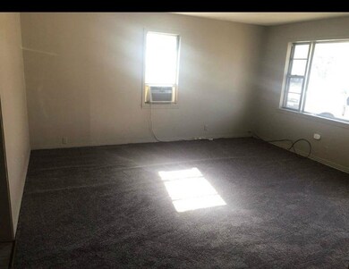 Spare room featuring cooling unit, baseboards, and