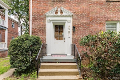 Property entrance featuring brick siding