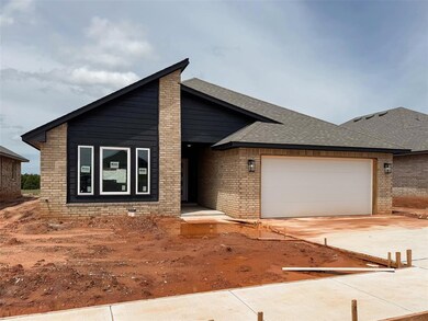 View of front of home with an attached garage, roo