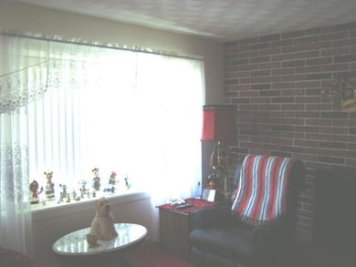 Living Room LR w/bay window and brick FP