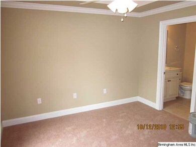 Master bedroom has tray ceiling and ceiling fan.