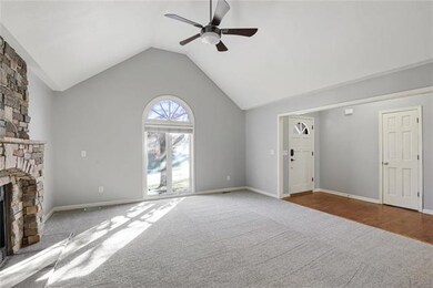 Living room with fireplace and picture window.