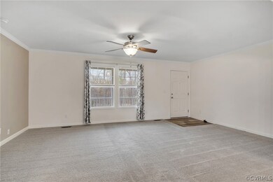 Empty room featuring ceiling fan, crown molding, a