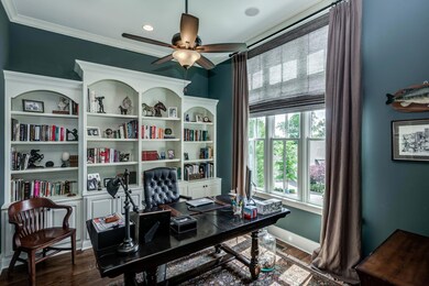 The office/library is just off the foyer for your convenience and has gorgeous built-ins for all your first editions.