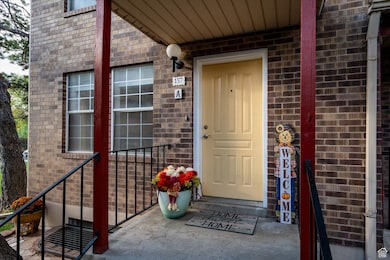 Entrance to property featuring brick siding