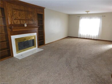 Great room with fireplace and newer frieze carpeti