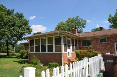 Enclosed porch at the rear of the home. Fenced yard too.