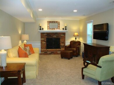 Carpeted Family Room with wood burning fireplace a