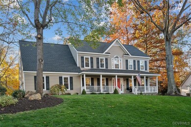 Colonial house with a porch and a front yard
