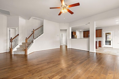 Unfurnished living room with dark wood-style floo