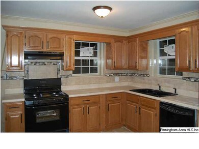 Kitchen with new wooden cabinets and black applian