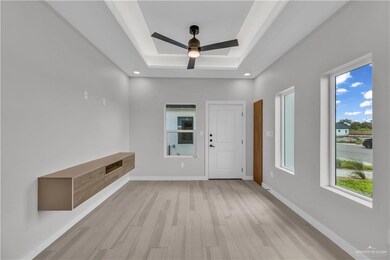 Kitchen with appliances with stainless steel finishes, modern cabinets, light countertops, open shelves, and recessed lighting