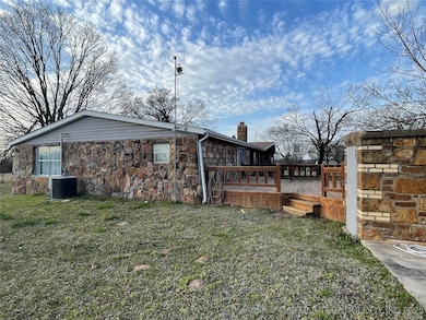 View of the side of the home with large deck and s