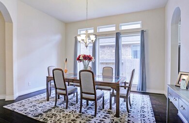 Side angle view of beautiful formal dining! Elegant brushed nickel chandelier!