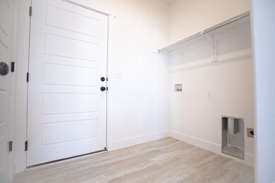 Full-size laundry room adjacent to garage with washer/dryer hookups.
