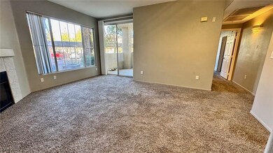 Unfurnished living room featuring carpet and a til