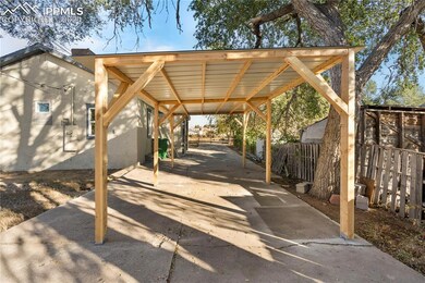 View of patio with a carport