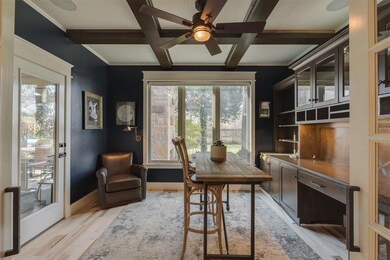 Office area with light wood-style floors, ceiling 