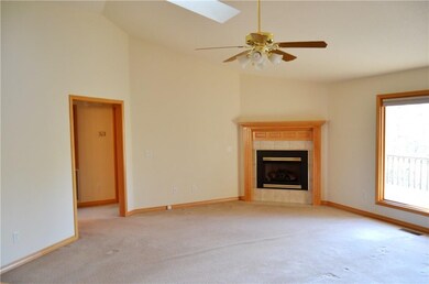 Living Room with Gas Log Fireplace. Notice the skylight.