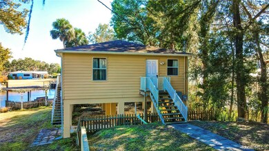 Front side view of home. Wooden fence along the fr