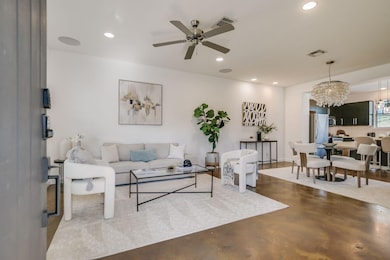 Living area featuring ceiling fan with notable ch