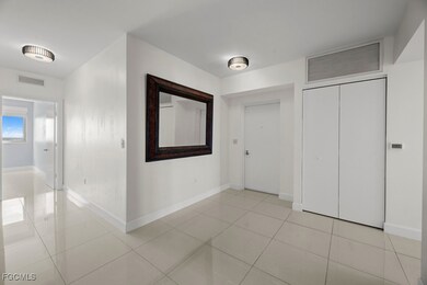 Corridor featuring light tile patterned floors and baseboards