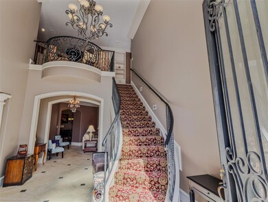 Staircase featuring ornamental molding, arched wal