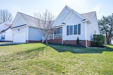 View of property with a garage and a front lawn