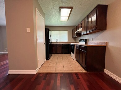 Kitchen featuring light wood-type flooring, a text