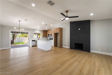 Unfurnished living room featuring ceiling fan, lof