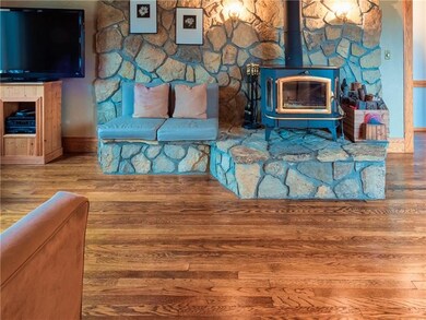 The main level features hardwood flooring, a stone