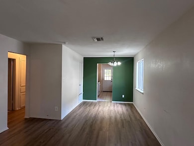 Unfurnished dining area with a chandelier and dar